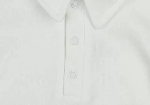 Egyszínű, elöl patentos, gallétos hosszú ujjú baba body-kombidressz.