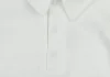 Egyszínű, elöl patentos, gallétos hosszú ujjú baba body-kombidressz.